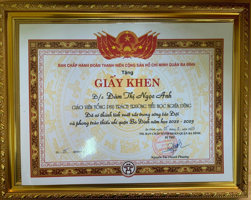 A gold framed certificate with red and black text

Description automatically generated